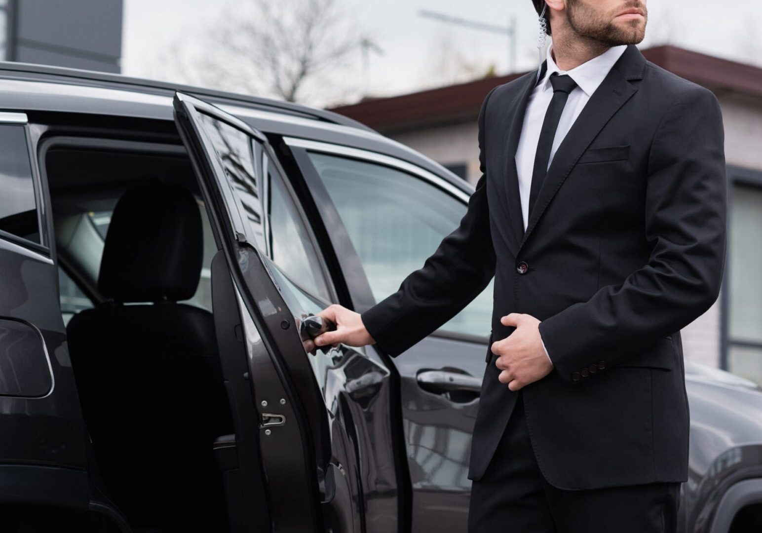 Man in suit opening car door